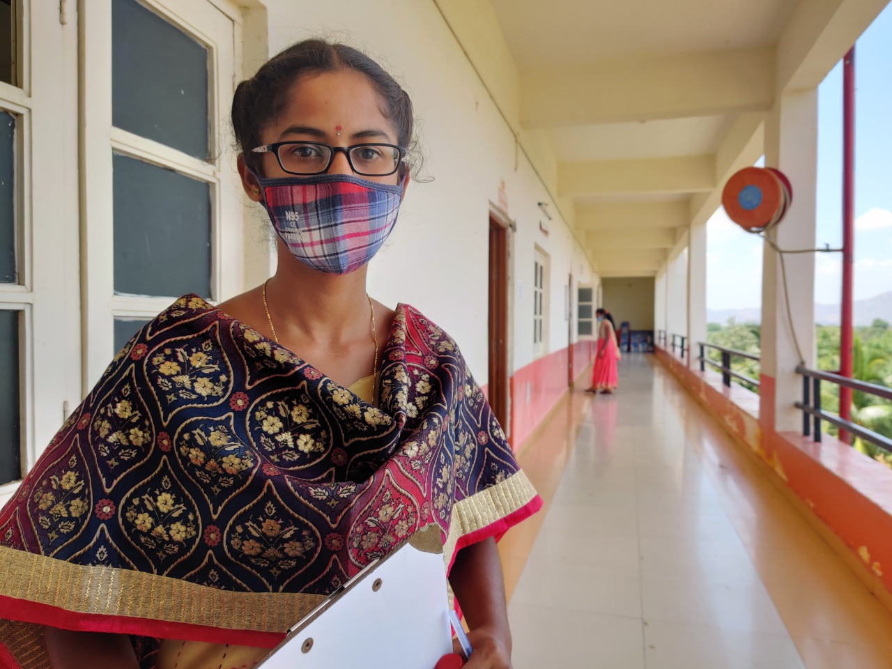 A girl in a mask who has just finished her scholarship exam