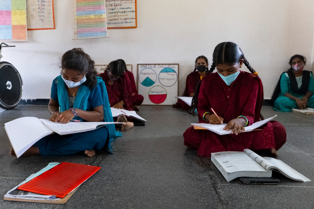 Students at RDT's inclusive school sit six feet apart from one another, working on their lessons.