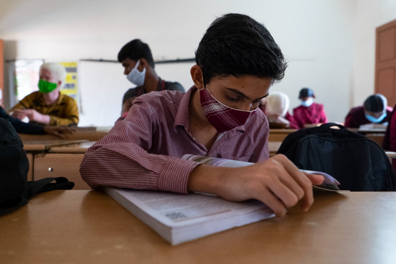 A boy bent over a textbook