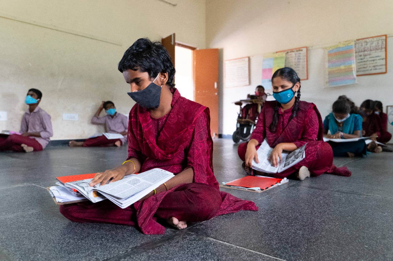 Masked students at RDT's inclusive school work quietly on their lessons.